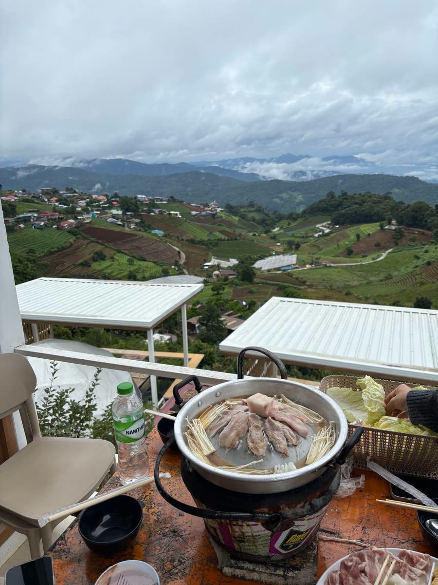 Mookata grill on a balcony overlooking misty mountains
